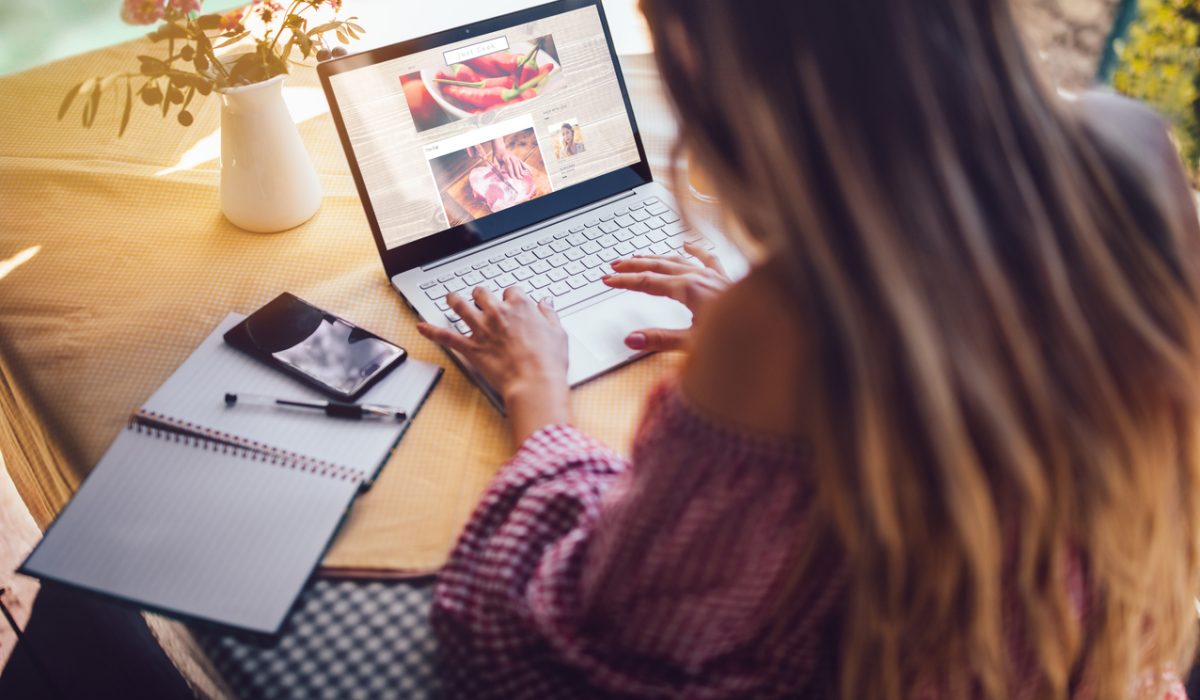 Female food blogger using laptop and working from home